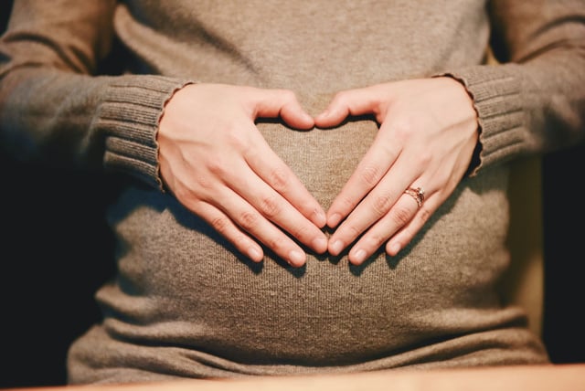 Woman Holding Her Pregnant Belly